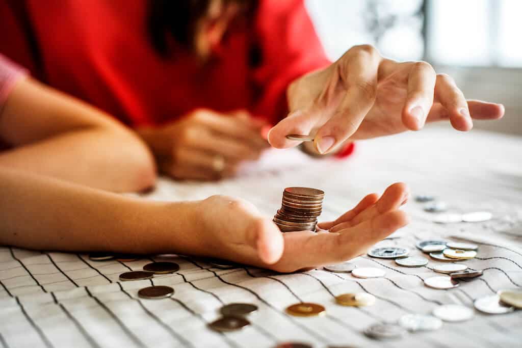 Parent and child counting coins after receiving their Child and Dependent Care Credit