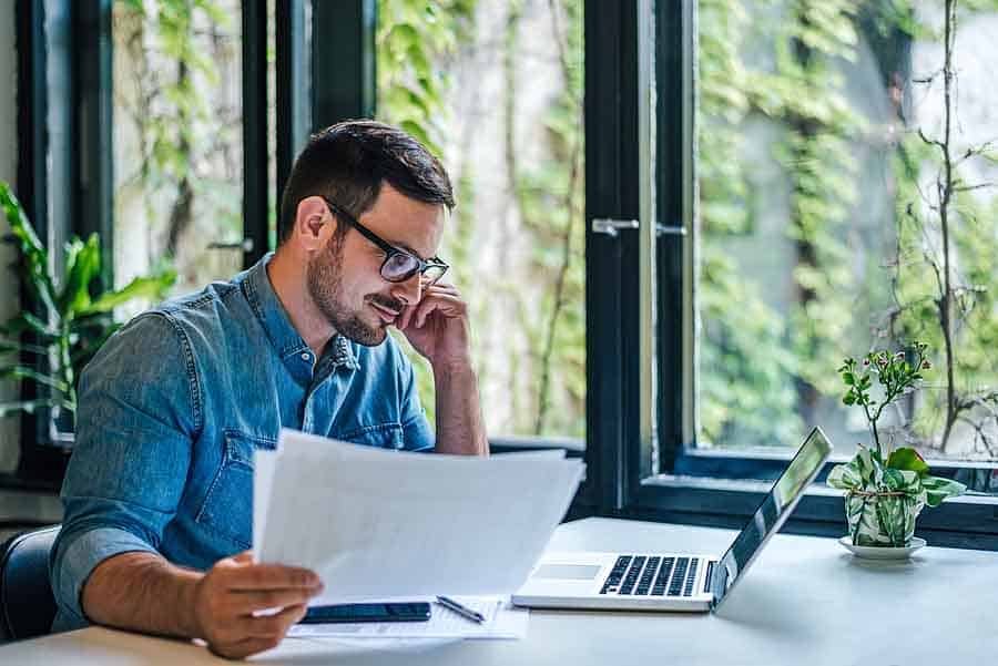 Man using a laptop for FBAR filing online.