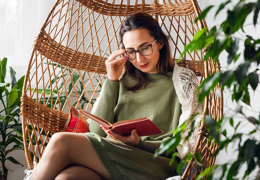 Woman reads her finances to make filing her expat taxes in 2023 easier.