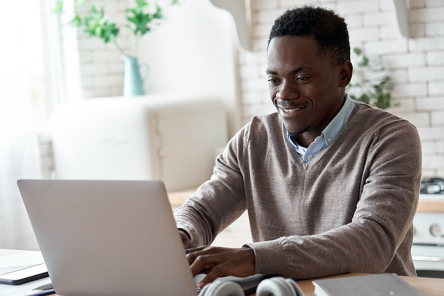 Man sits at his laptop to file his FATCA with My Expat Taxes