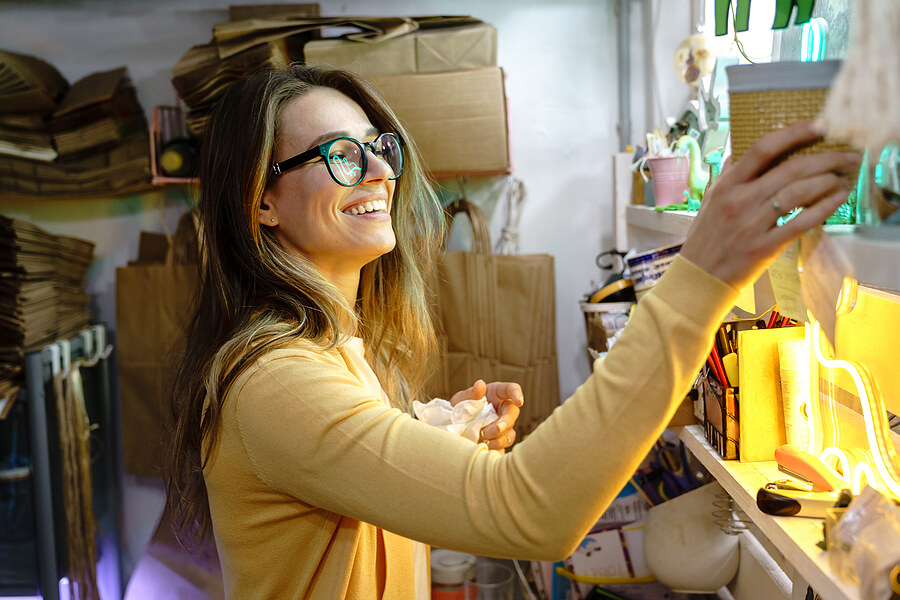 Self-Employed expat woman in her studio abroad not thinking about taxes.