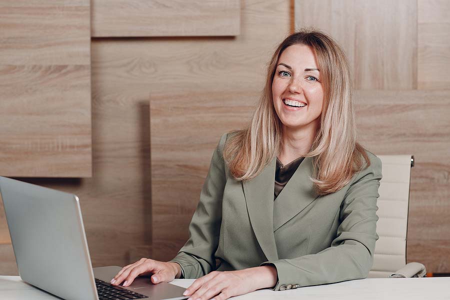 Photo of a young, blonde, US expat Tax Accountant at her laptop