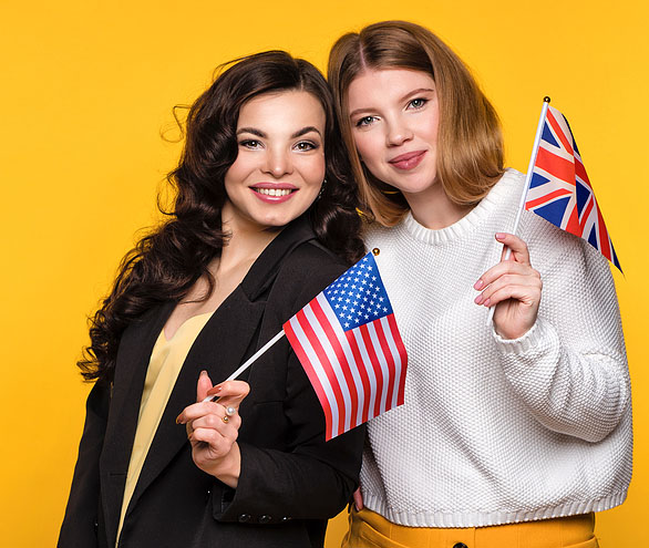 Two women, one is holding a US flag and they other is holding a UK flag. Again signifying the US UK treaty.