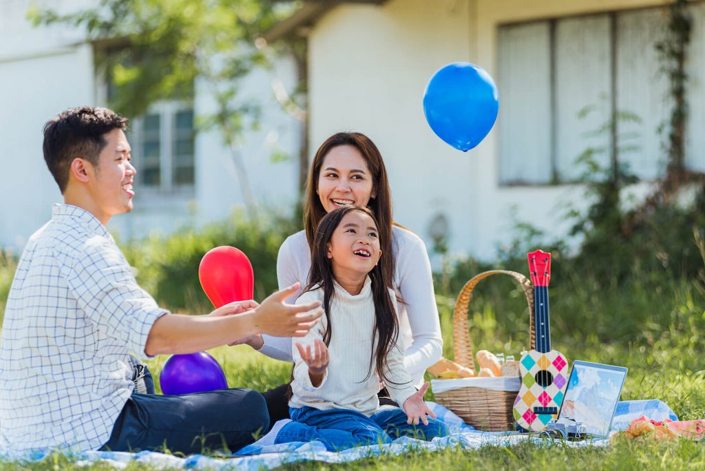 Child and Family enjoying a nice afternoon having a picnic because they got child tax credit for American families abroad