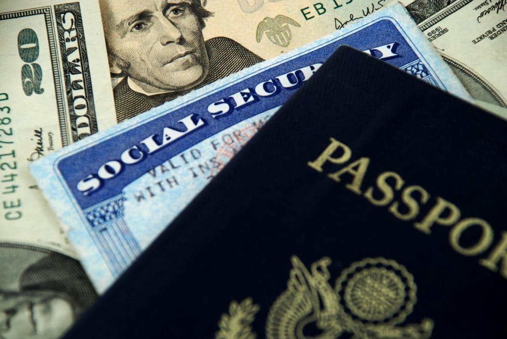 Photo of American money, passport and social security number. All used for the American expat social security tax and benefits.