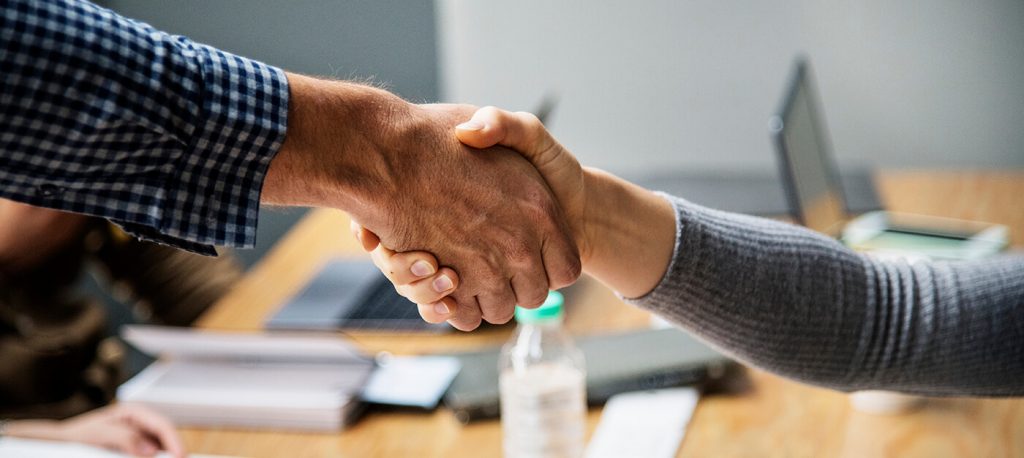 In-person interview when the deal is made and you are apart of the team. Shown with a handshake.