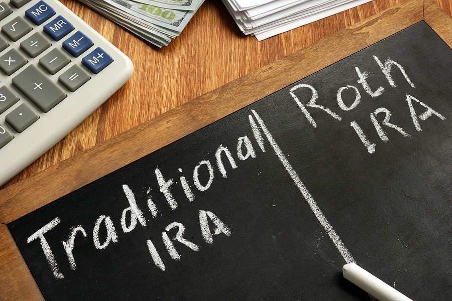 Photo of a chalkboard with highlights saying "Traditional IRA" and "Roth IRA". These are American Expat IRA contribution limits.