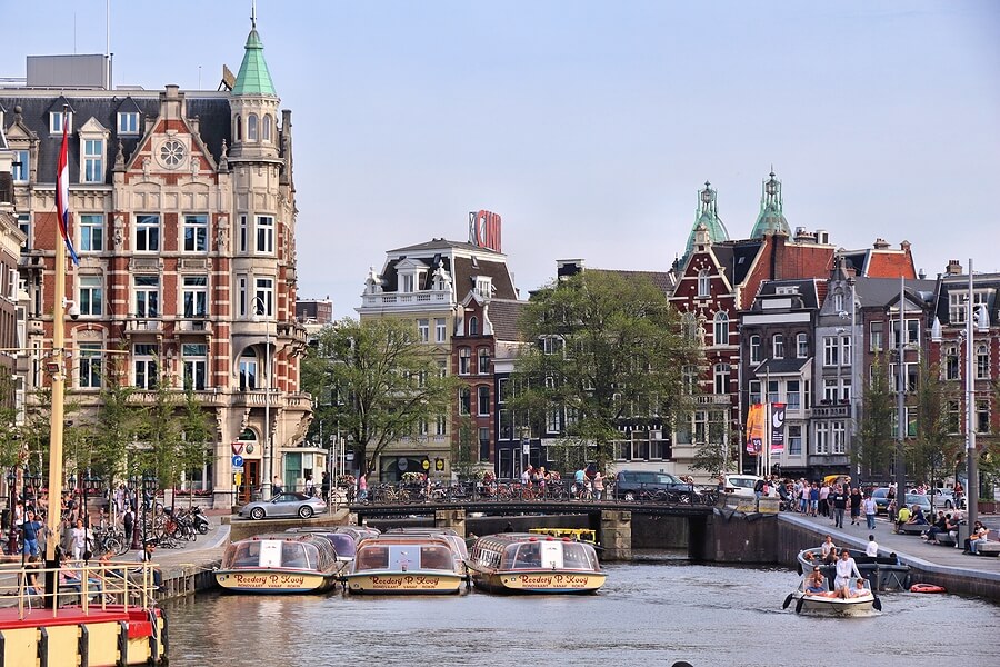 A photo of a river surrounded by apartment building in Amsterdam. Perfect for filing us expat taxes from the Netherlands.