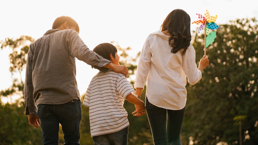 American expat family walk in a park together. Not worrying about filling us taxes with family abroad.